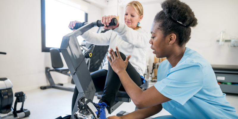 Person helping another person with strength training