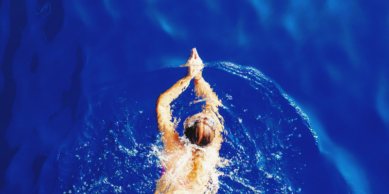 Overhead view of a person swimming in a pool