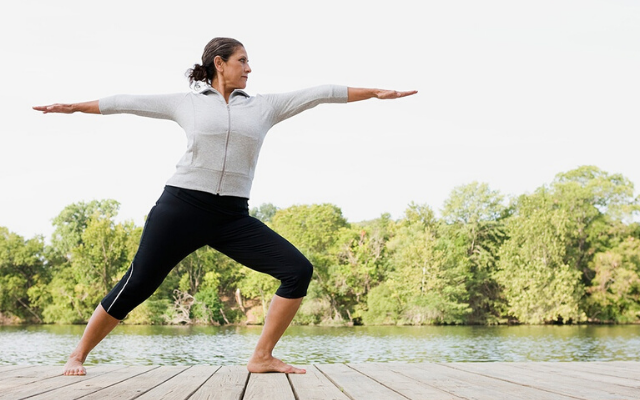 Person in athletic gear doing yoga on a dock